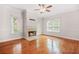 Spacious living room with hardwood floors, fireplace, and a ceiling fan at 557 Lawton Sw St, Atlanta, GA 30310