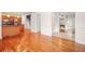 Open-concept living spaces with hardwood floors, connecting kitchen, stairs, and living room with fireplace at 557 Lawton Sw St, Atlanta, GA 30310