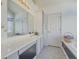 Bathroom featuring white countertops, cabinets, a bathtub, and built-in storage at 690 Winding River Dr, Lawrenceville, GA 30046
