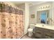 Charming bathroom with unique shower curtain, vanity, and neutral walls at 690 Winding River Dr, Lawrenceville, GA 30046