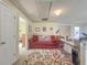 Bright bonus room with a red sofa and a neutral rug at 690 Winding River Dr, Lawrenceville, GA 30046