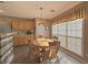 Cozy dining area featuring a round table, natural light from large windows, and wooden cabinetry at 690 Winding River Dr, Lawrenceville, GA 30046