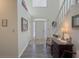 Bright foyer showcasing wood floors, white stairs, a high ceiling, and a lovely front door at 690 Winding River Dr, Lawrenceville, GA 30046