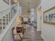 Open-concept foyer with high ceilings, wood floors, staircase, and views into the living room at 690 Winding River Dr, Lawrenceville, GA 30046