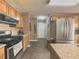 Functional kitchen with wood cabinets, stainless steel appliances, and a tile backsplash at 690 Winding River Dr, Lawrenceville, GA 30046