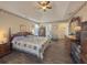 Bright main bedroom offering ample space, a ceiling fan, and access to ensuite bathroom at 690 Winding River Dr, Lawrenceville, GA 30046