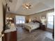 Spacious main bedroom with tray ceilings, ceiling fan, wood floors and natural lighting at 690 Winding River Dr, Lawrenceville, GA 30046