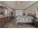 Large main bedroom with wooden floors, patterned wallpaper, and abundant natural light at 690 Winding River Dr, Lawrenceville, GA 30046