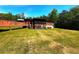 View of backyard featuring a wooden deck and expansive lawn at 105 Doe Dr, Temple, GA 30179