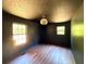 This bedroom features wood floors, neutral paint, and abundant light at 105 Doe Dr, Temple, GA 30179