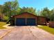 Two-car garage with blue doors and driveway at 105 Doe Dr, Temple, GA 30179
