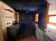 The kitchen features ample counter space, wooden shelves, and unique backsplash tiling at 105 Doe Dr, Temple, GA 30179