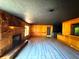 Spacious living room with stone fireplace, wood paneling and hardwood floors at 105 Doe Dr, Temple, GA 30179