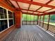 Inviting screened-in porch with wood flooring and a charming lattice design, offering scenic views at 105 Doe Dr, Temple, GA 30179