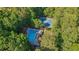 Aerial view of a community pool and tennis courts surrounded by lush trees, showcasing recreational amenities at 1880 Redbourne Dr, Atlanta, GA 30350