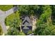 Aerial view of the house with a dark roof, patio with furniture and beautiful landscaping at 1880 Redbourne Dr, Atlanta, GA 30350