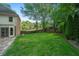 Expansive backyard with lush green lawn, mature trees, and private fencing, ideal for recreation and relaxation at 1880 Redbourne Dr, Atlanta, GA 30350
