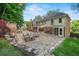 Large backyard patio with stone fireplace, outdoor seating, and well-manicured lawn for outdoor enjoyment at 1880 Redbourne Dr, Atlanta, GA 30350