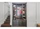 Built-in bar area with glass shelving and adjacent staircase at 1880 Redbourne Dr, Atlanta, GA 30350