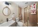 Well-lit bathroom with single sink, toilet, and a shower with glass doors at 1880 Redbourne Dr, Atlanta, GA 30350