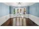 Dining room with chair rail, bay window, and hardwood flooring at 1880 Redbourne Dr, Atlanta, GA 30350