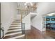 Grand foyer with high ceilings, hardwood floors, and staircase with iron spindles at 1880 Redbourne Dr, Atlanta, GA 30350