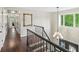 Foyer with wrought iron railing and chandelier at 1880 Redbourne Dr, Atlanta, GA 30350