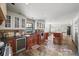 Gourmet kitchen with professional-grade appliances, wine fridge, and stone tile flooring at 1880 Redbourne Dr, Atlanta, GA 30350