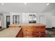 Eat in kitchen island with stone countertops, stainless steel fridge, and white cabinets at 1880 Redbourne Dr, Atlanta, GA 30350