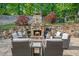 Inviting stone outdoor fireplace and seating area, perfect for entertaining guests in a backyard oasis at 1880 Redbourne Dr, Atlanta, GA 30350