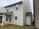 View of the back of the home with patio, covered porch, and neatly trimmed grass for outdoor enjoyment at 241 Coral Cir, Mcdonough, GA 30253