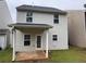 The backyard offers a covered patio, door to the back, and is partially fenced at 241 Coral Cir, Mcdonough, GA 30253