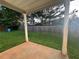 View of the backyard from under the covered patio with a wooden fence and green grass at 241 Coral Cir, Mcdonough, GA 30253