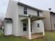 This home's backyard features a covered patio, a door to the backyard, and tan siding at 241 Coral Cir, Mcdonough, GA 30253