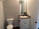 Cozy bathroom featuring a vanity with a granite countertop and a decorative mirror at 241 Coral Cir, Mcdonough, GA 30253