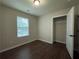 Well-lit bedroom with a window letting in natural light and closet with wood-look floors at 241 Coral Cir, Mcdonough, GA 30253