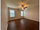 Spacious bedroom featuring hardwood floors, a ceiling fan, and natural light at 241 Coral Cir, Mcdonough, GA 30253