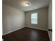 Well-lit bedroom with natural light from the window, featuring wood-look floors at 241 Coral Cir, Mcdonough, GA 30253
