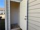 This entryway features a white door, tan siding, and provides access to the home's interior at 241 Coral Cir, Mcdonough, GA 30253