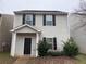 Charming two-story home featuring black shutters and mature landscaping at 241 Coral Cir, Mcdonough, GA 30253