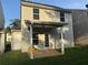 Rear exterior view of a two-story home with neutral siding, covered patio and green lawn at 241 Coral Cir, Mcdonough, GA 30253