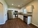 Modern kitchen with stainless steel appliances, white cabinetry, and sleek countertops, ideal for cooking and entertaining at 241 Coral Cir, Mcdonough, GA 30253