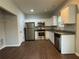 Modern kitchen with stainless steel appliances, white cabinets, and granite countertops, ideal for cooking and entertaining at 241 Coral Cir, Mcdonough, GA 30253