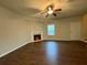 Inviting living room featuring a fireplace and wood-look floors, perfect for gathering and relaxation at 241 Coral Cir, Mcdonough, GA 30253