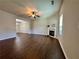 Open-concept living room with dark hardwood flooring and a fireplace, flowing into the dining area at 241 Coral Cir, Mcdonough, GA 30253