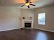 Inviting living room featuring a fireplace, ceiling fan, and ample natural light at 241 Coral Cir, Mcdonough, GA 30253