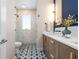Modern bathroom featuring a tiled shower, stylish vanity with marble countertop, and unique patterned floor tiles at 28 Peachtree Hills Ne Ave, Atlanta, GA 30305