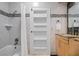 Bathroom with granite countertop vanity, a tiled shower/tub, and a mirrored medicine cabinet at 28 Peachtree Hills Ne Ave, Atlanta, GA 30305