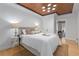 Stylishly furnished bedroom featuring hardwood floors, a tray wood ceiling, and neutral decor at 28 Peachtree Hills Ne Ave, Atlanta, GA 30305