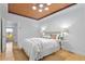 Cozy bedroom featuring a wood ceiling, hardwood floors, and a comfortable bed at 28 Peachtree Hills Ne Ave, Atlanta, GA 30305